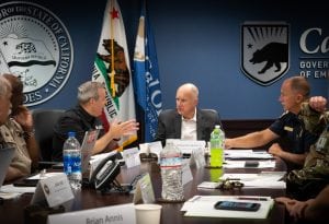 Governor Brown sitting at a table with state officials